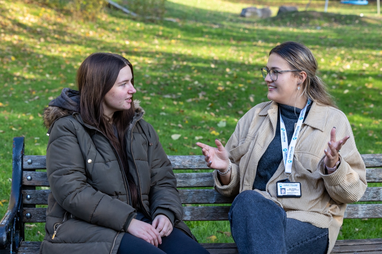 Julian House colleague talking to a member of thecommunity.