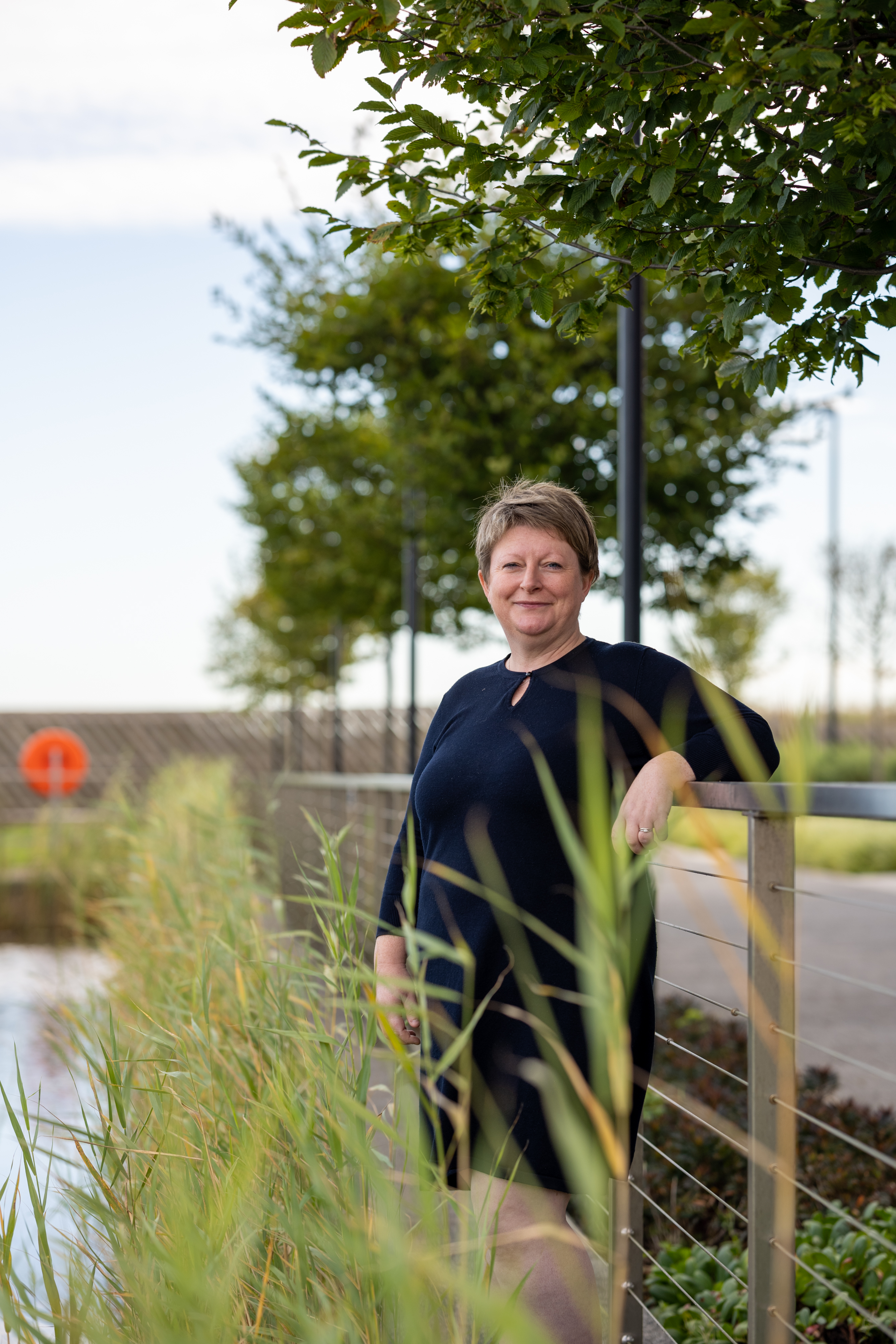 Glynnis stands with plants around her