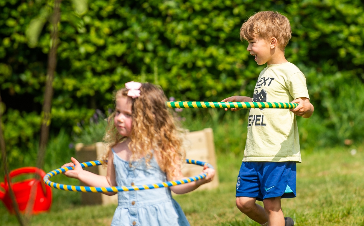 Children hula hooping at tree planting event