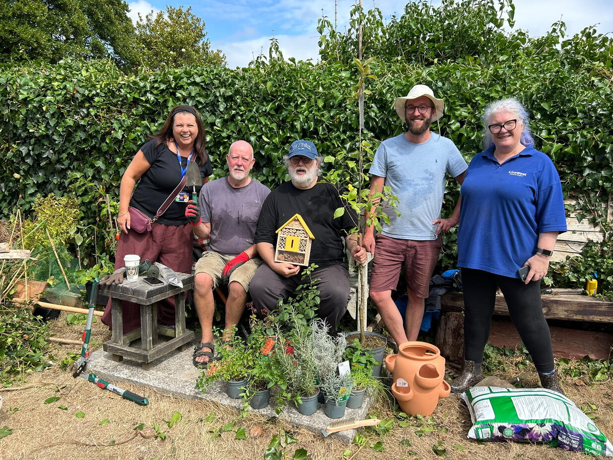 Aberfall House residents and LiveWest colleague smiling in the garden