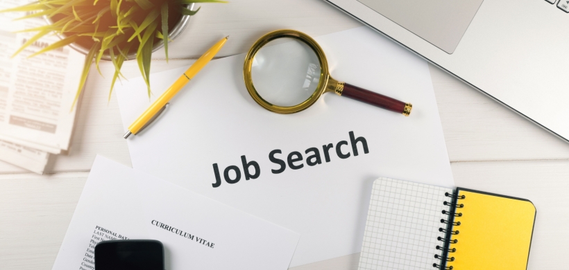 image of a laptop, cv and magnifying glass, with the words 'job search'
