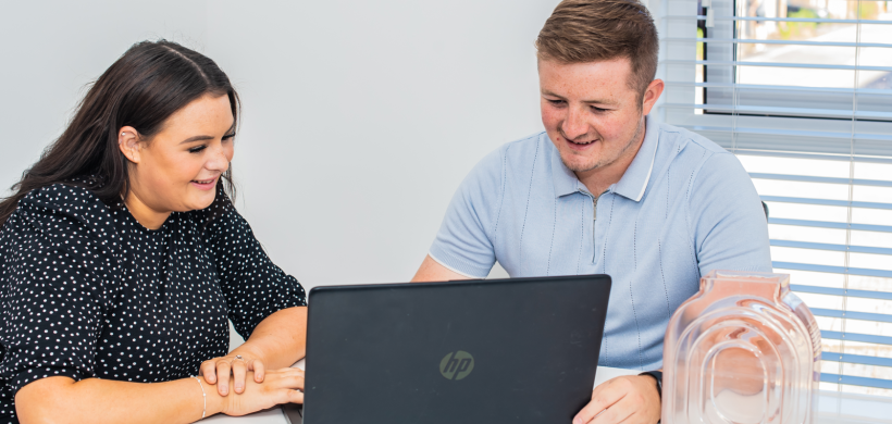 smiling people using a computer