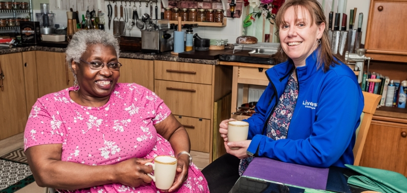 Our InFocus member, Sue smiling alongside one of our colleagues.