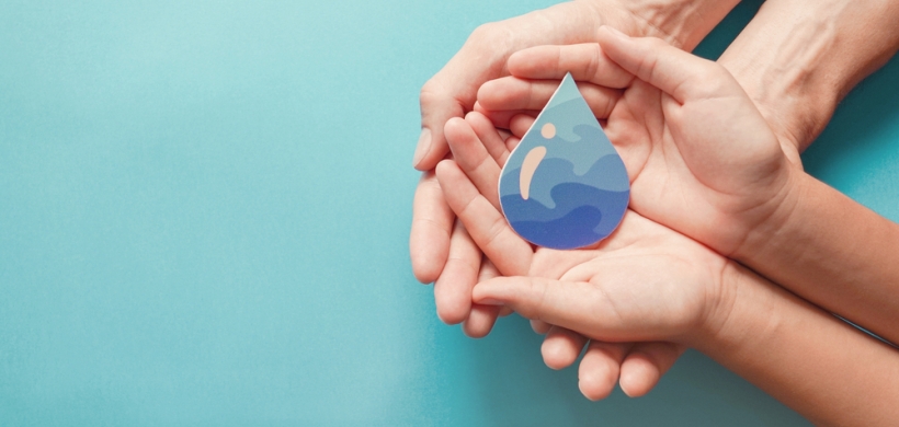 hands holding a water drop prop