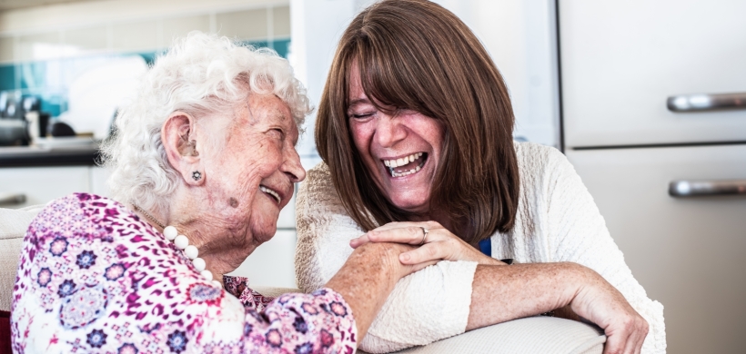 Delcie (left) smiling alongside one of our supported housing colleagues.