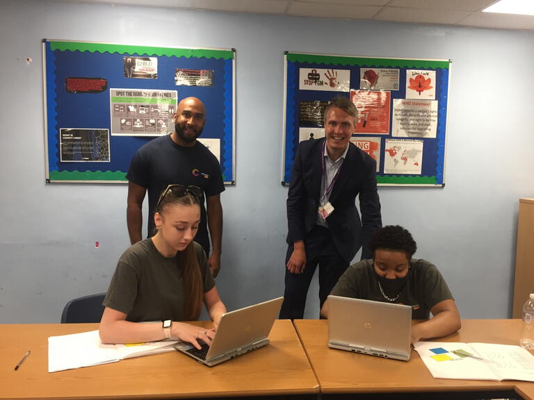 Teacher Jake Mensah and Dan Carter Headteacher at Learning Partnership West School with students and their new laptops LiveWest.