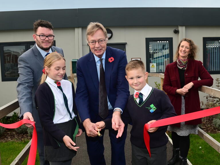 Councillor Dan Brown, Sir Gary Streeter MP, Judy Talbot, Sherford Community Trust Co-ordinator. Front row: Sophia and Harry, pupils at Sherford Vale School.