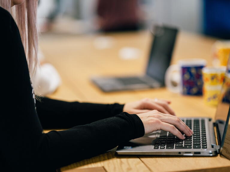 Someone using a laptop. 