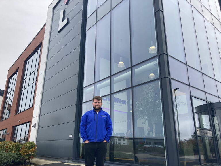 Ben Logan smiling outside of our Exeter office.