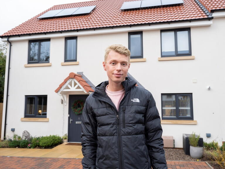 First-time buyer, Jack Benjamin outside his new energy-efficient home.