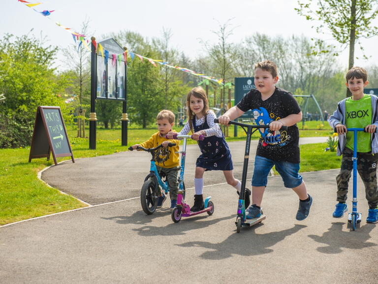 children on bikes and scooters