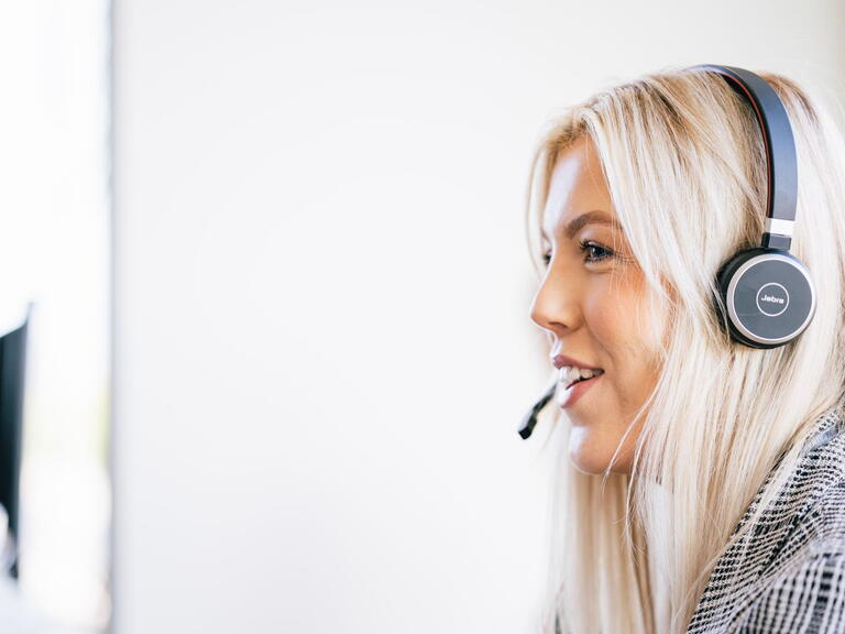 Image of a LiveWest colleague speaking to someone on a headset.
