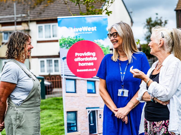 Image of three female LiveWest colleagues and customers laughing.
