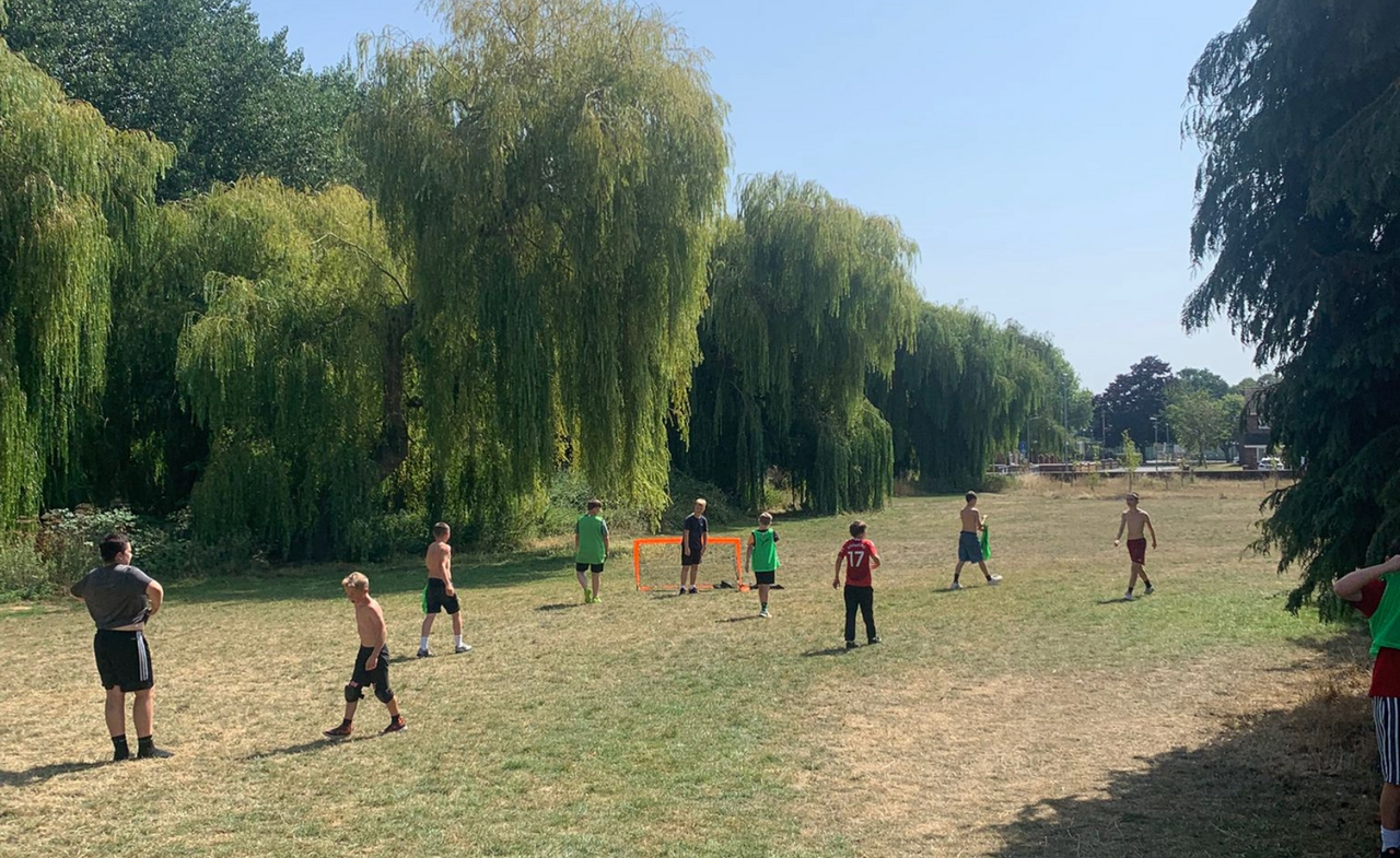 Image of young people playing ball games on a field in one of the 'summer sessions' in Bridgwater