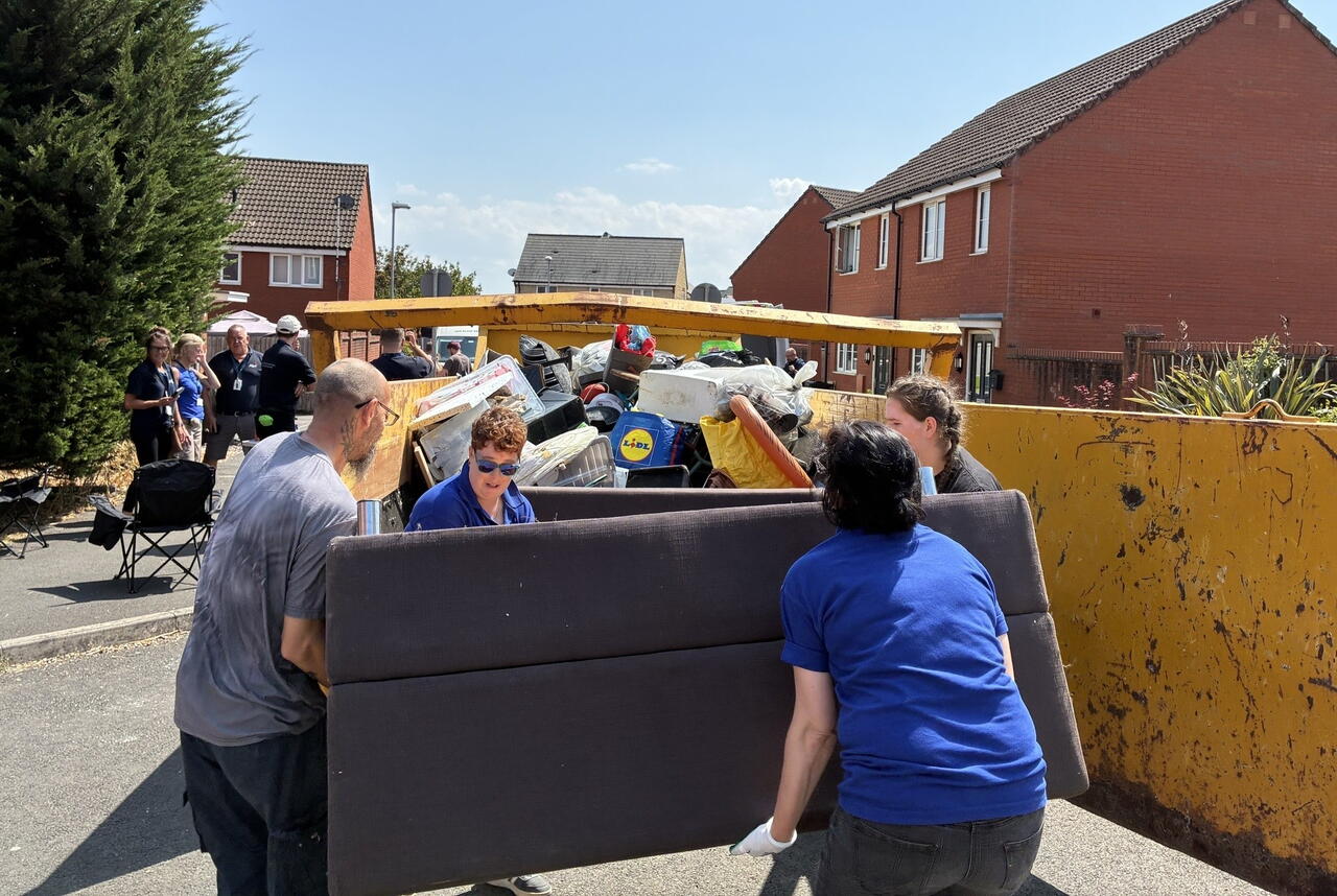 LiveWest residents and colleagues carrying bulky waste to skips