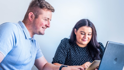 A couple using a laptop. 