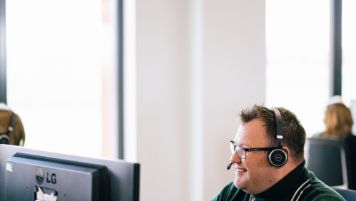 LiveWest colleague talking to a customer using a headset.