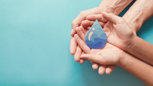 hands holding a water drop prop