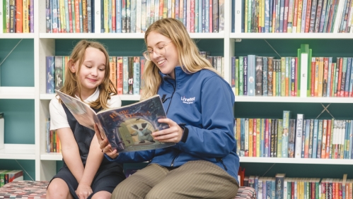 colleague reading book with young resident