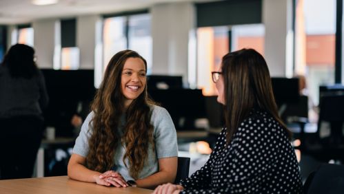 Colleagues talking and smiling