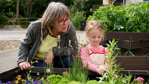 Image of two LiveWest residents looking at their community garden in Sparkford.