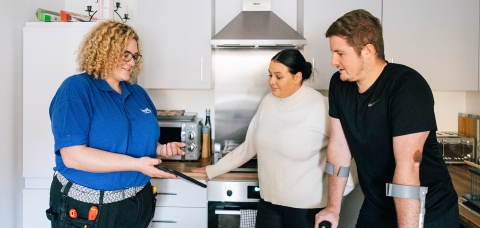 LiveWest colleague talking with two customers in a kitchen.